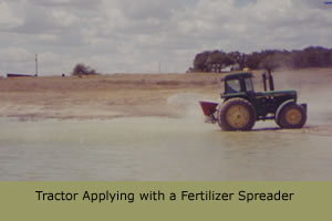 Tractor applying with a fertilizer spreader